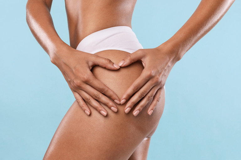 Model photo of woman making heart sign on buttocks