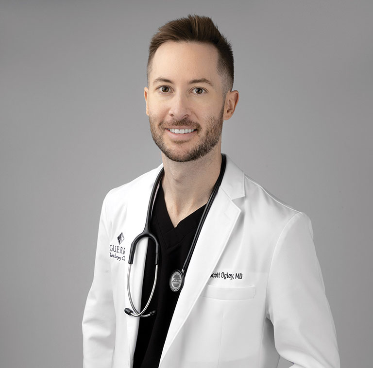 Dr. Scott Ogley wearing a white lab coat with stethoscope